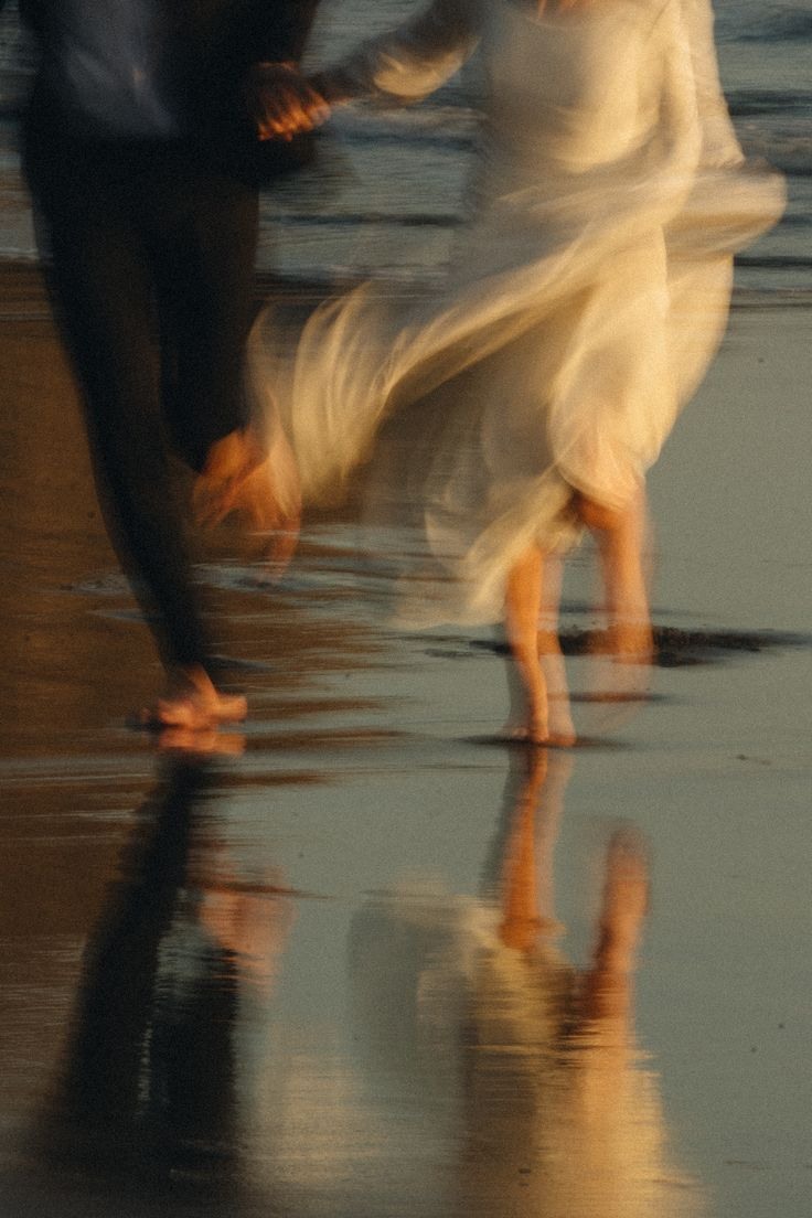 A dream of us one day: a couple holding hands by the sea in warm evening light